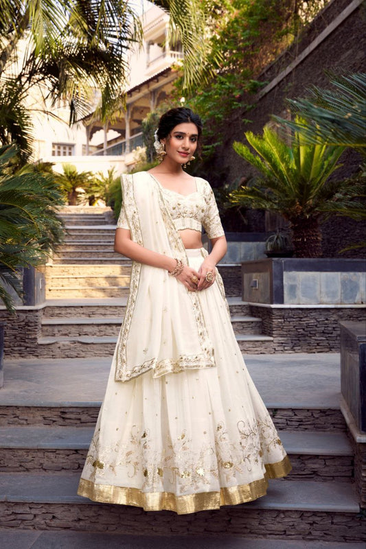 Off-white foil work silk wedding lehenga choli with dupatta